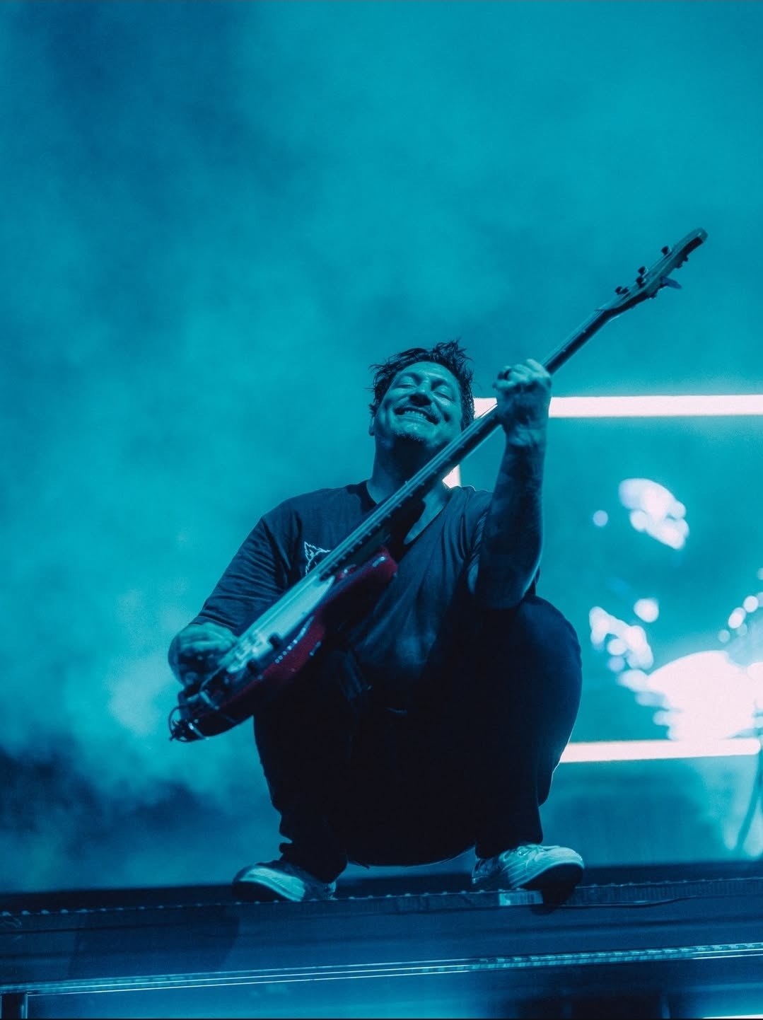 Neon-lit Bass Guitarist on Stage